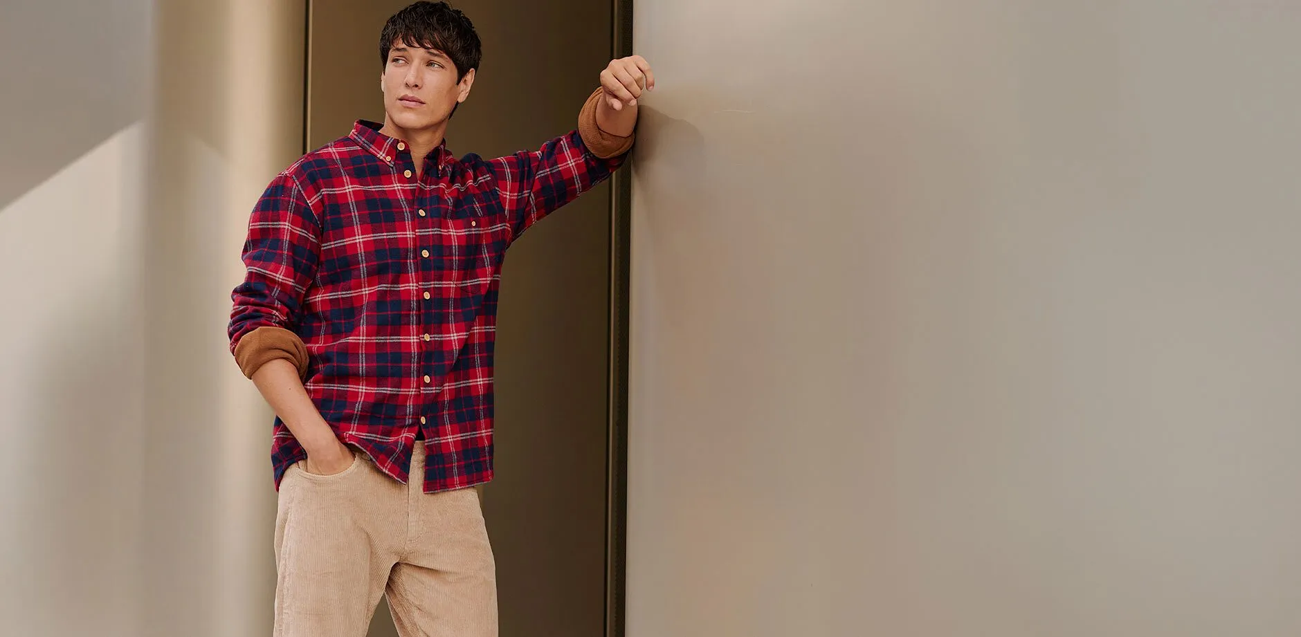 Lež&eacute;rn&iacute; look s kostkovanou ko&scaron;il&iacute; v červeno-modr&eacute; barvě a b&eacute;žov&yacute;mi kalhotami.