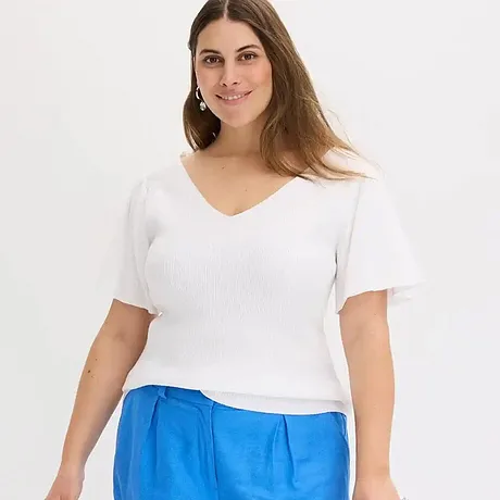 Schlichtes weißes T-Shirt mit V-Ausschnitt, kombiniert mit leuchtendblauen Hosen für einen frischen Sommerlook.