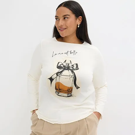 Krémový svetr s motivem parfémové lahvičky a mašlí.