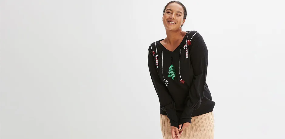 Černý svetr s vánočním motivem.